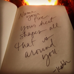 Notebook page with a handwritten quote, set against a warm fire: 'Name your fire, your heart shapes all that is around you.'